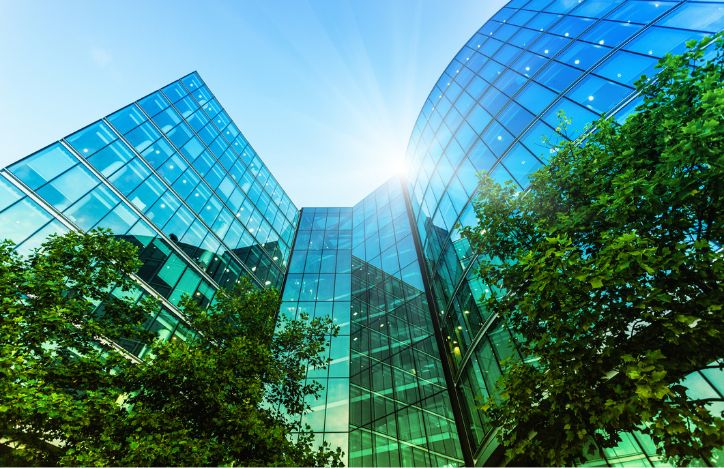Looking Up At A Modern Office With Green Trees Outside