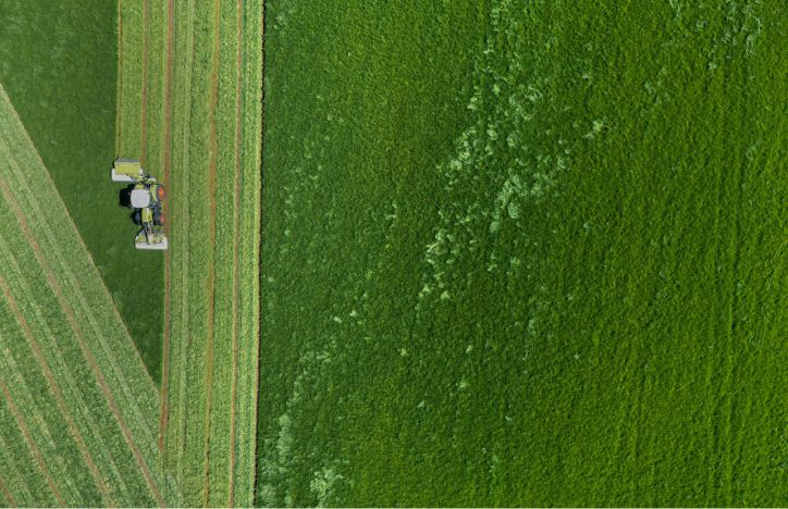Aerial View Of Tractor Mowing Field