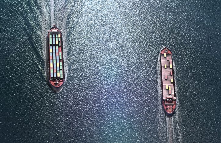 Two Cargo Ships Passing Each Other In The Sea