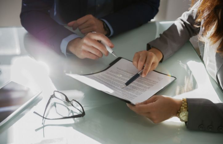 Two Professionals Analysing A Document